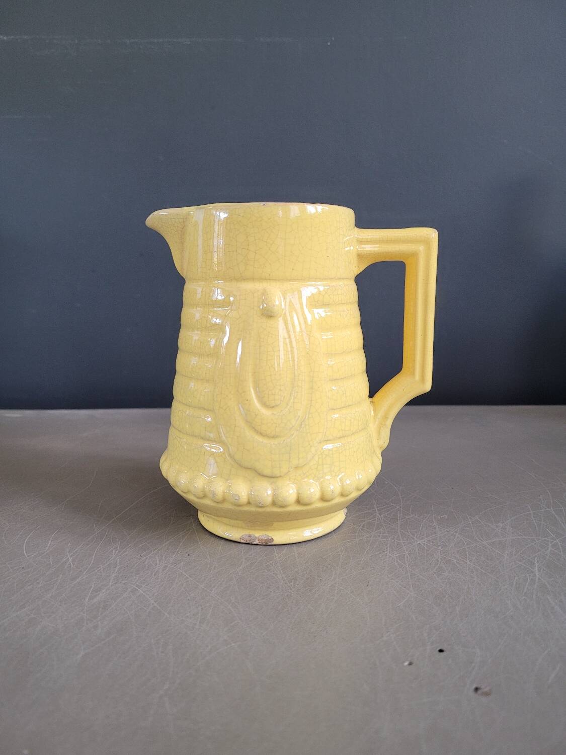 Yellow milk jug with reliefs