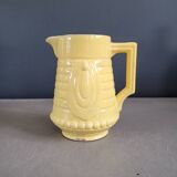Yellow milk jug with reliefs