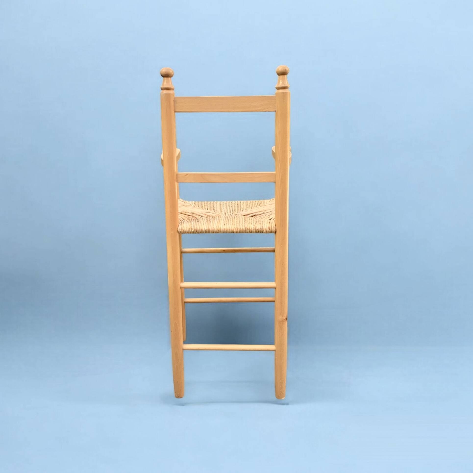 Old wooden and straw high chair for children