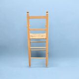 Old wooden and straw high chair for children