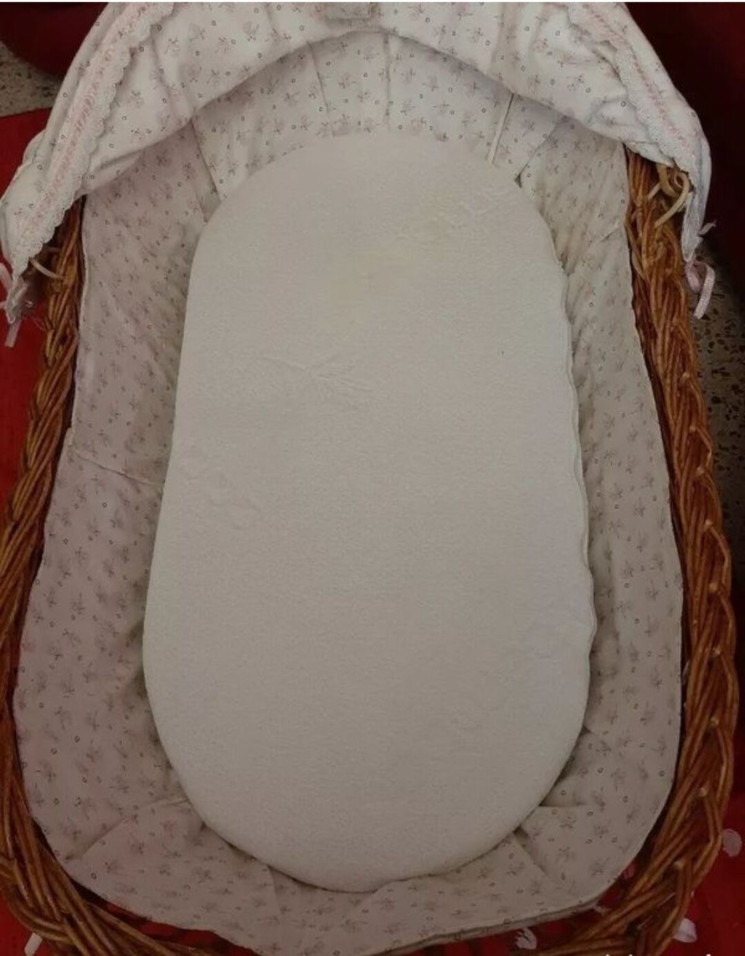 Vintage wicker cradle on wheels from the 1970s.