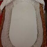 Vintage wicker cradle on wheels from the 1970s.