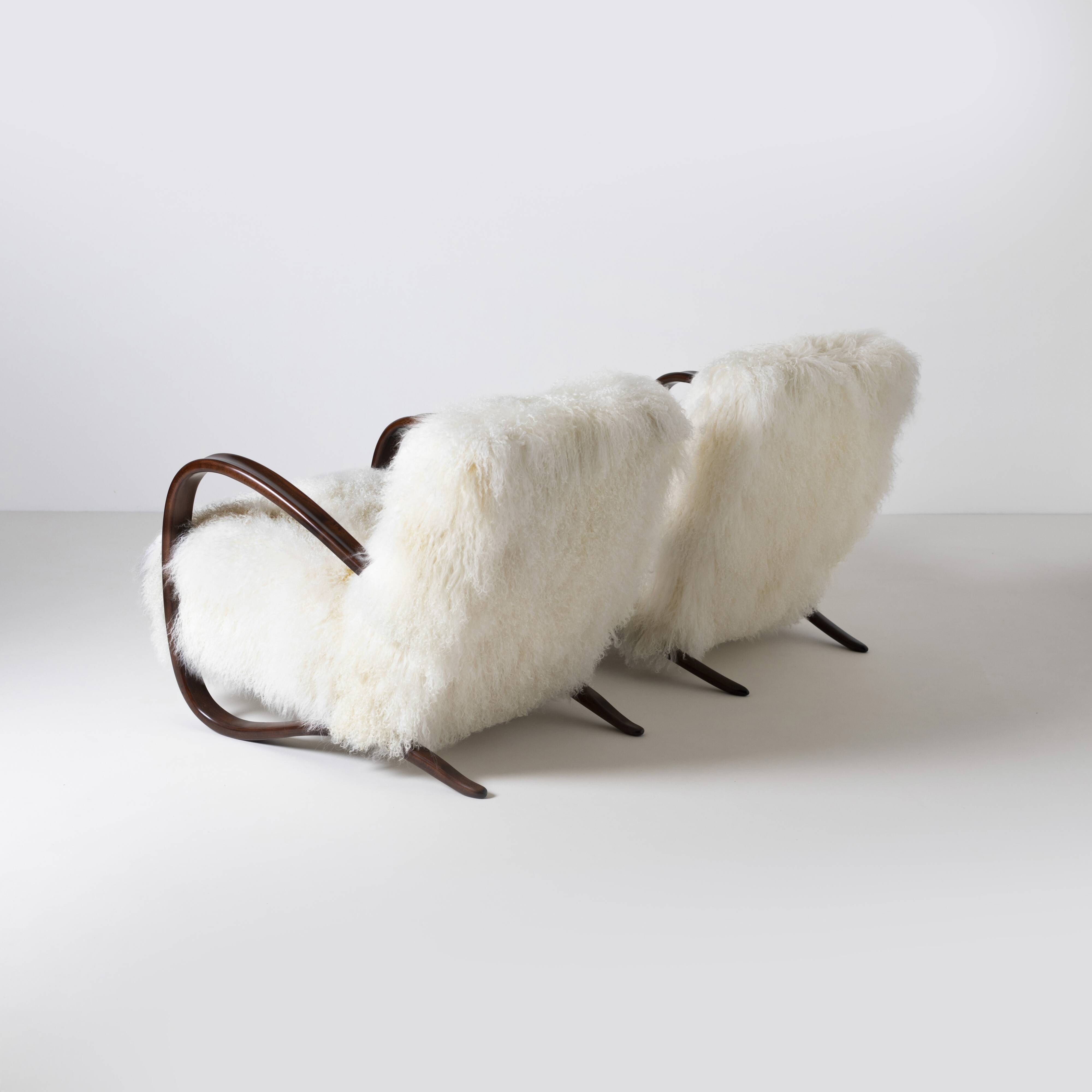 Pair of Jindrich Halabala H 269 lounge chairs in mongolian sheepskin