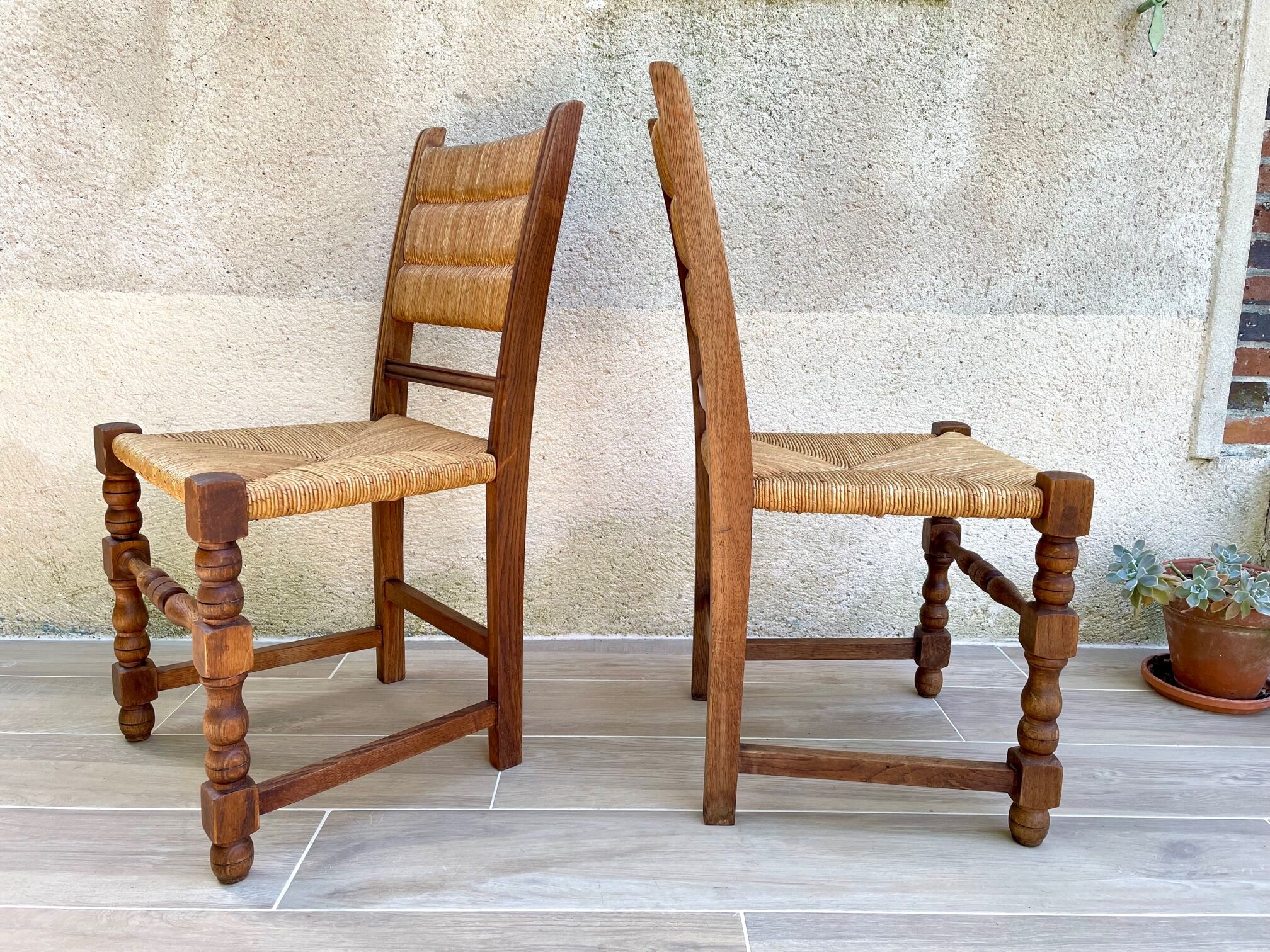 Pair of straw and solid oak chairs