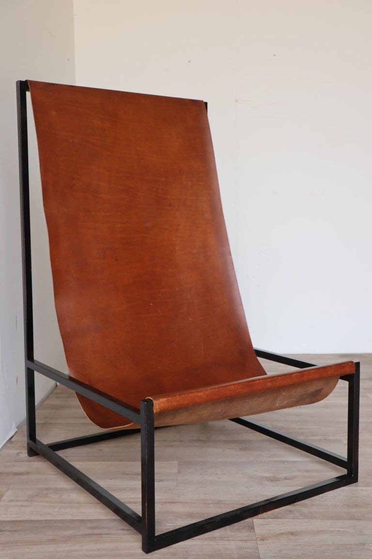 Pair of vintage armchairs in stretched leather and metal structure