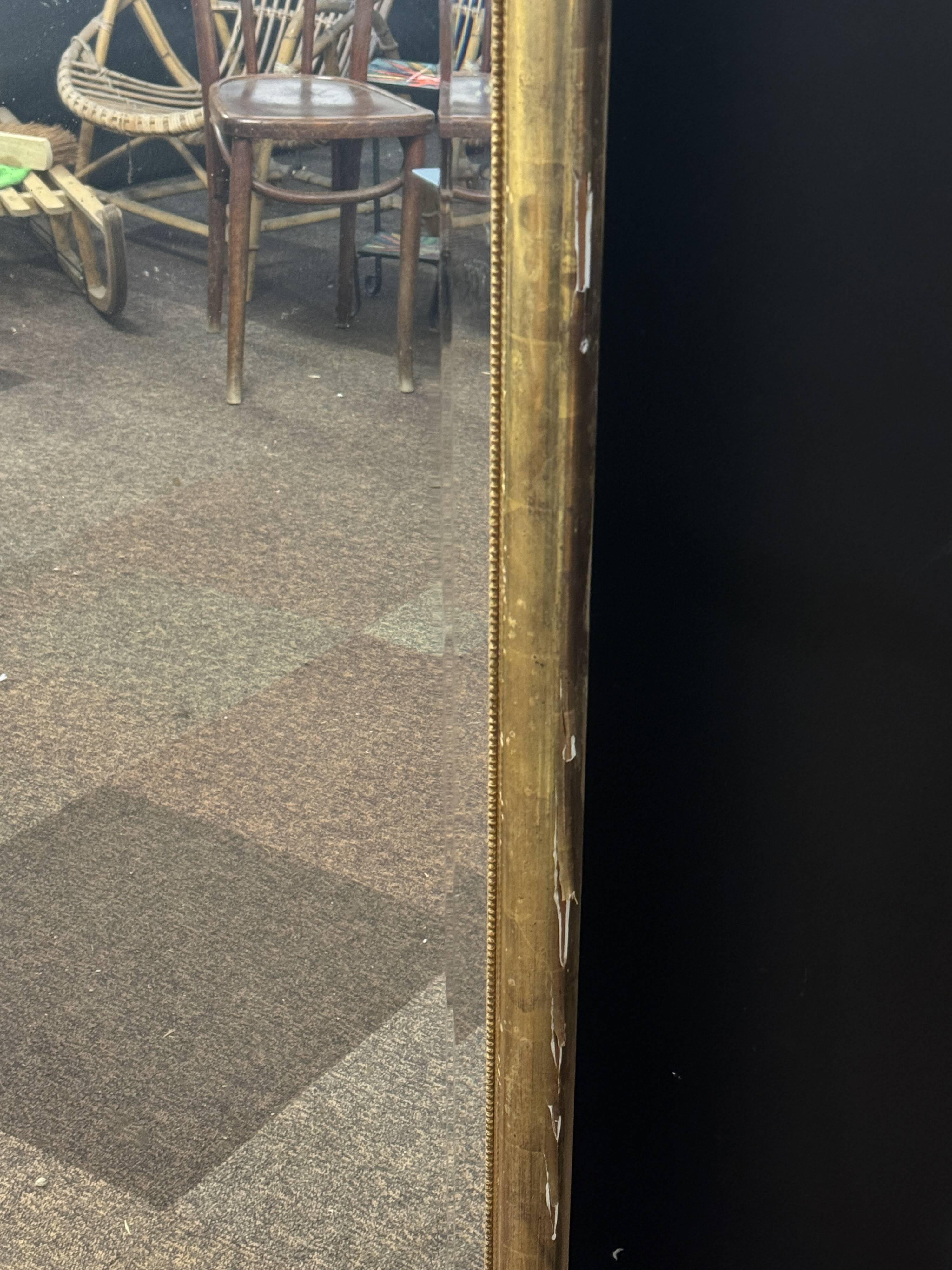 Large mirror with a gold frame