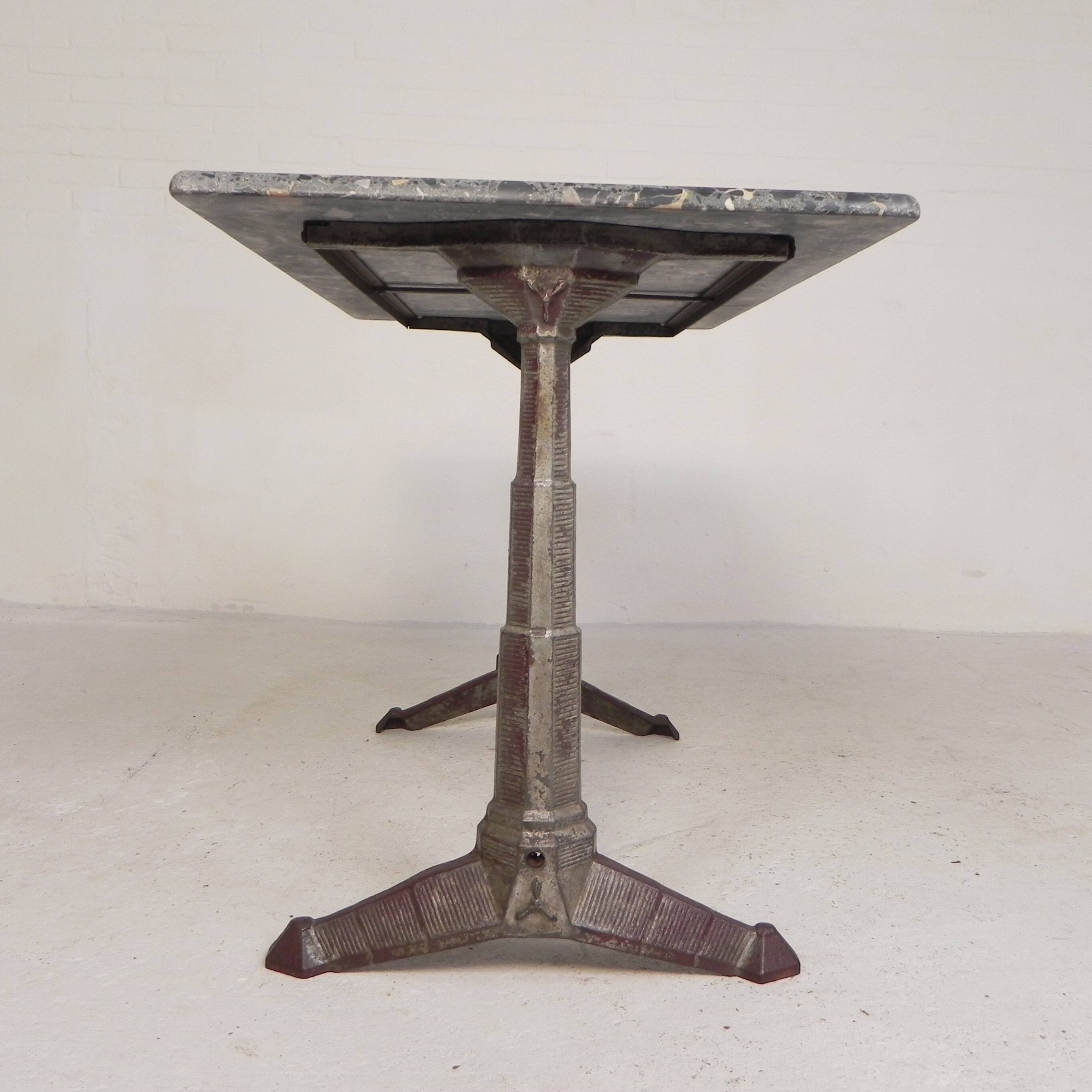 Bistro table with a marble top on a cast iron frame, 1930s.