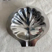 Set of 12 stainless steel scallop shells, 1970s-80s.