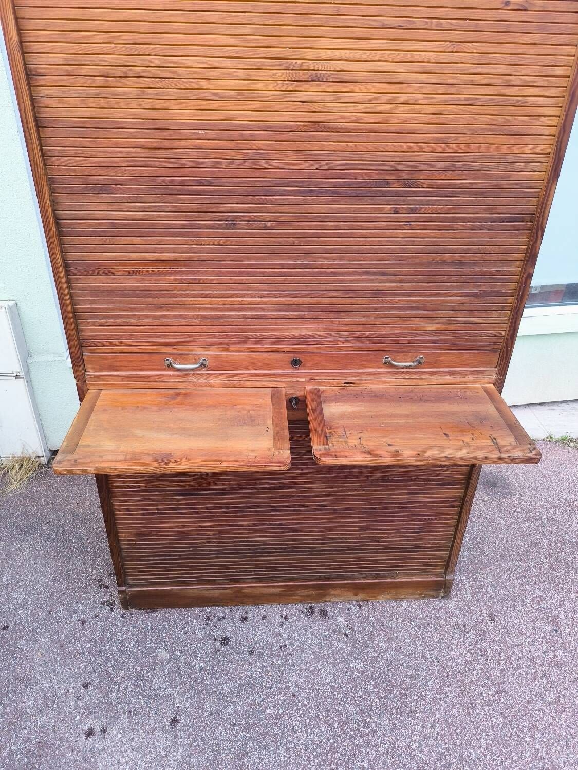 Vintage 1940s secretary desk with wooden curtains, storage, and shutters.