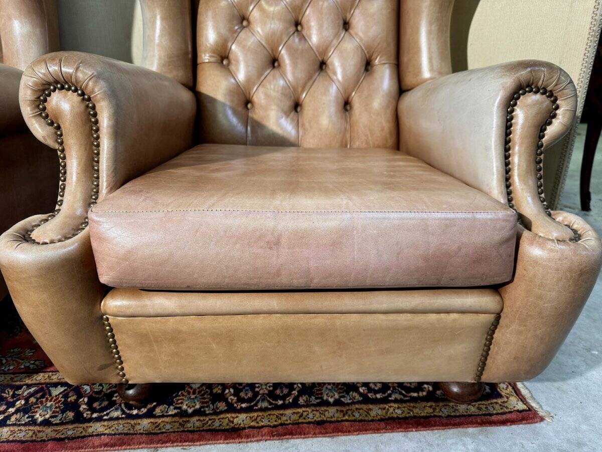 Pair of Chesterfield leather wingback armchairs
