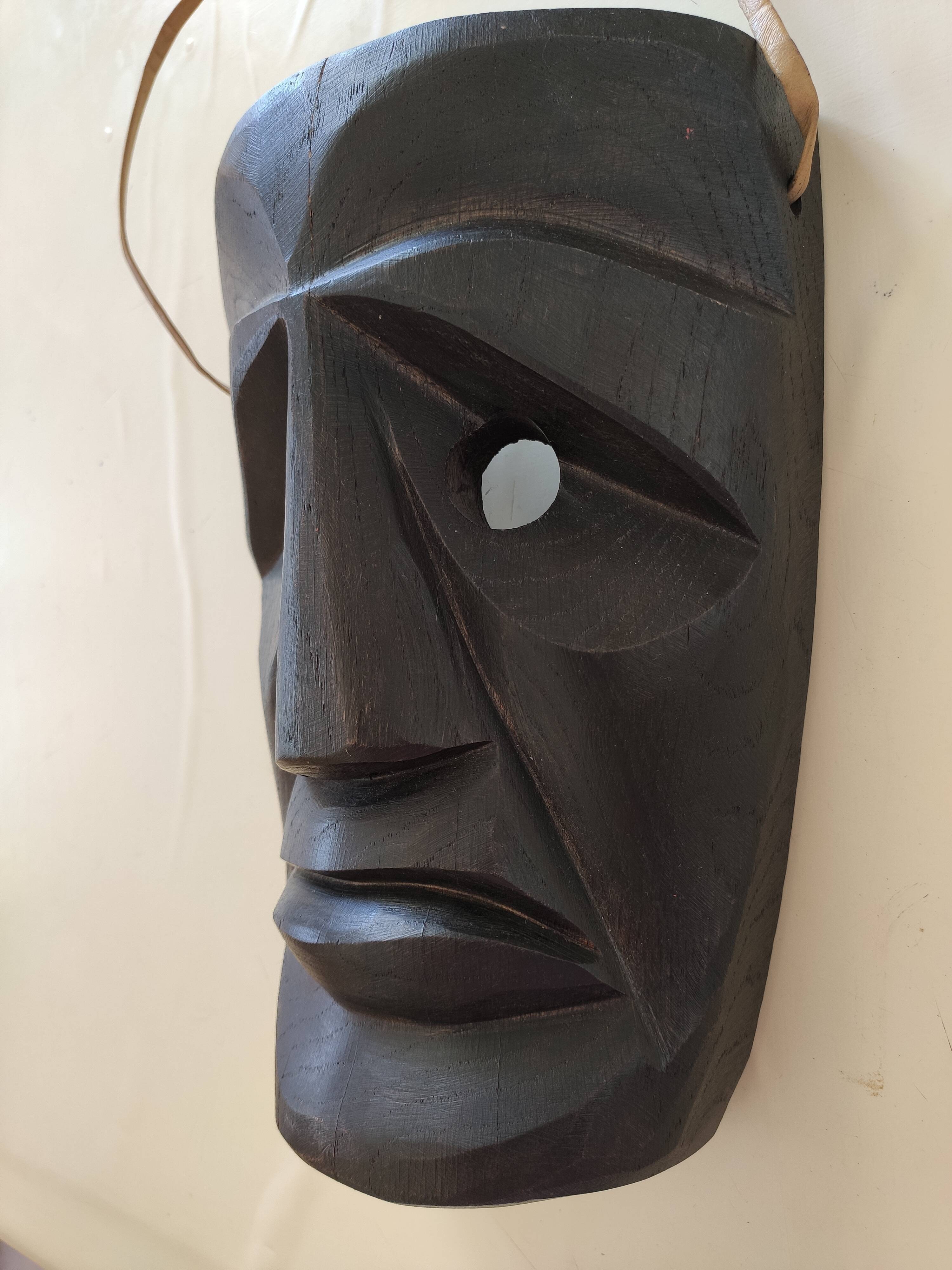 Ethnic ebony wood mask for display or hanging.