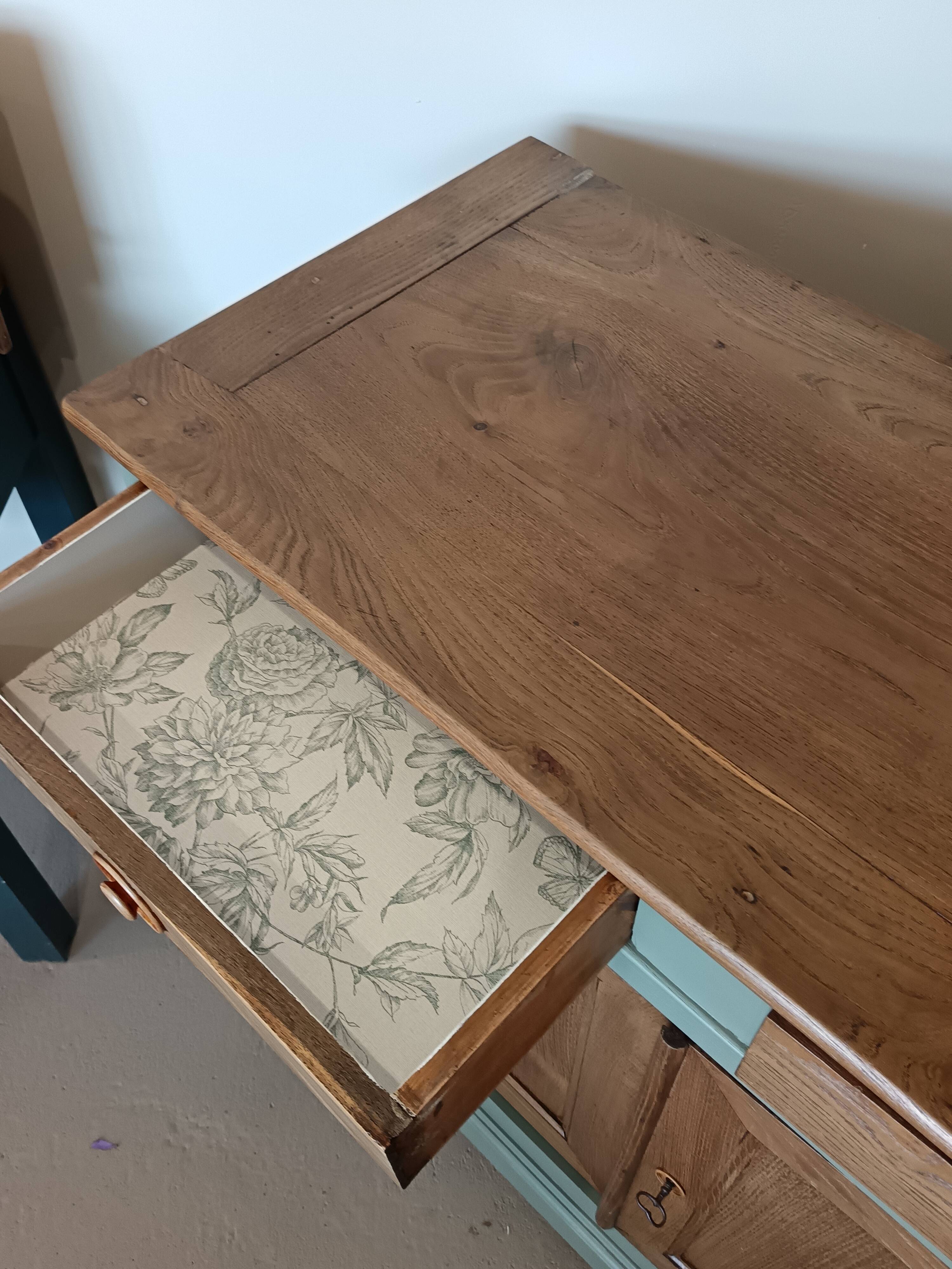 Buffet made of natural wood and bronze green.