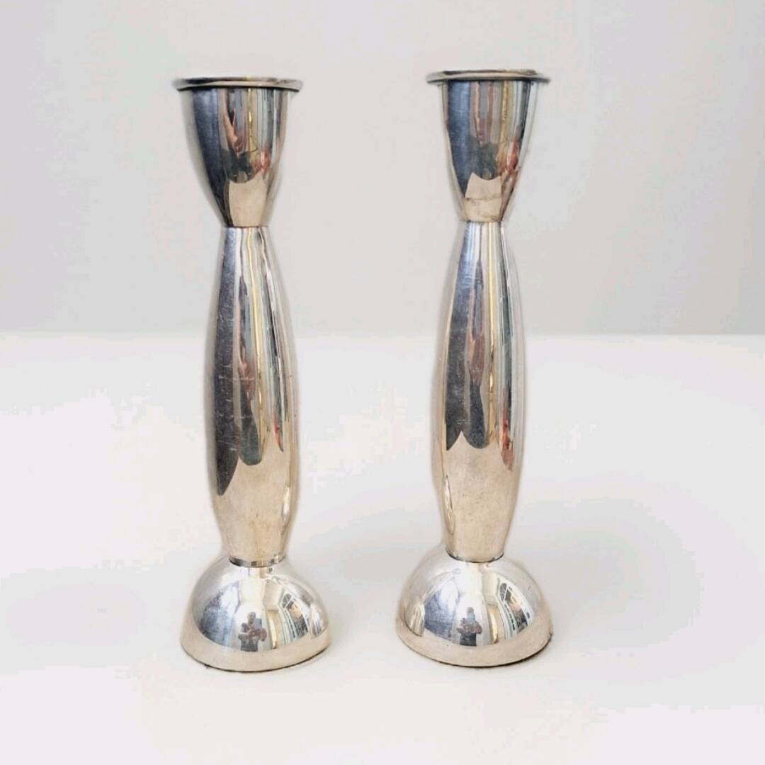 Pair of silver-colored metal candlesticks.