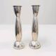 Pair of silver-colored metal candlesticks.