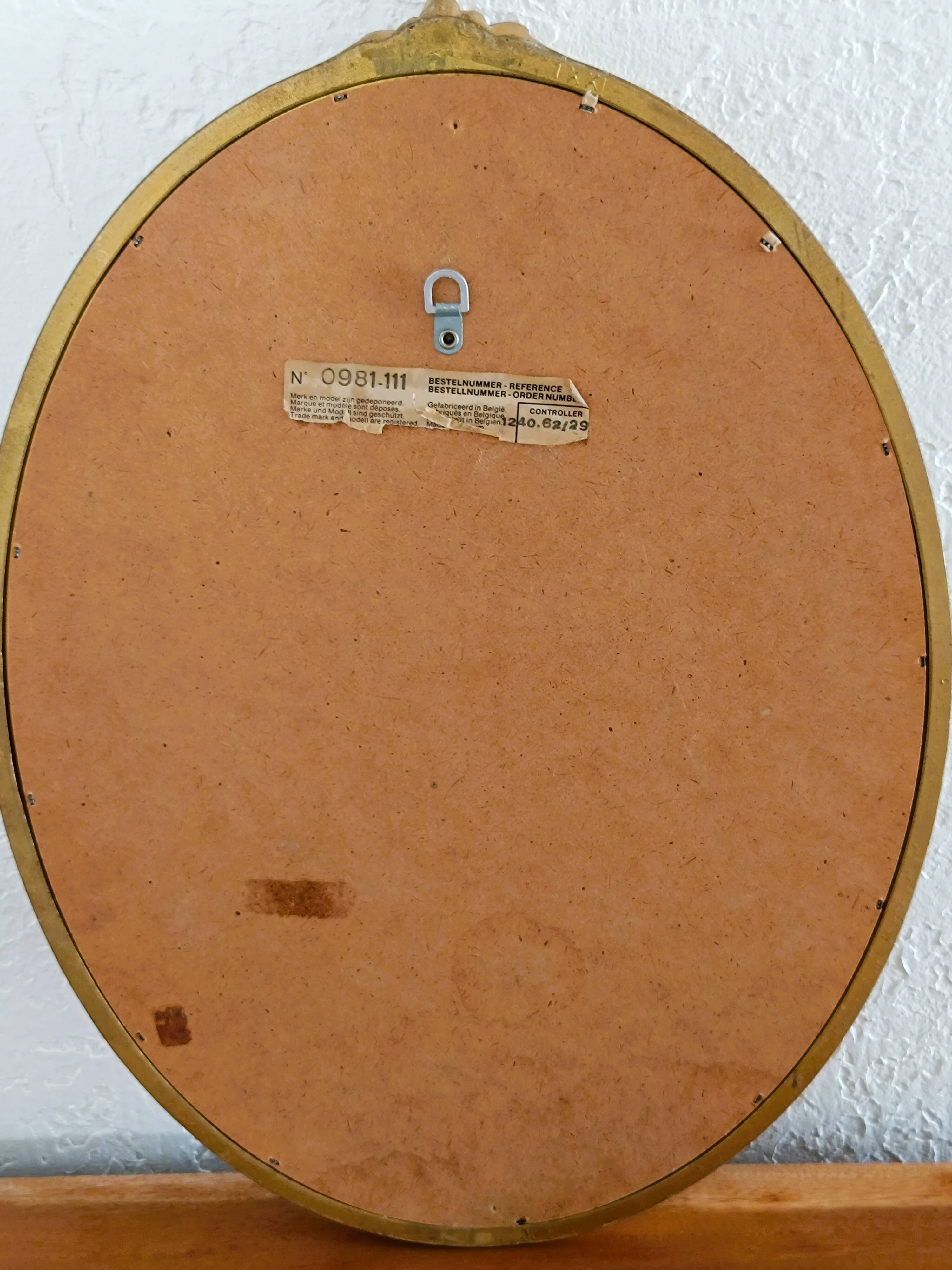 Antique oval-shaped gilded mirror