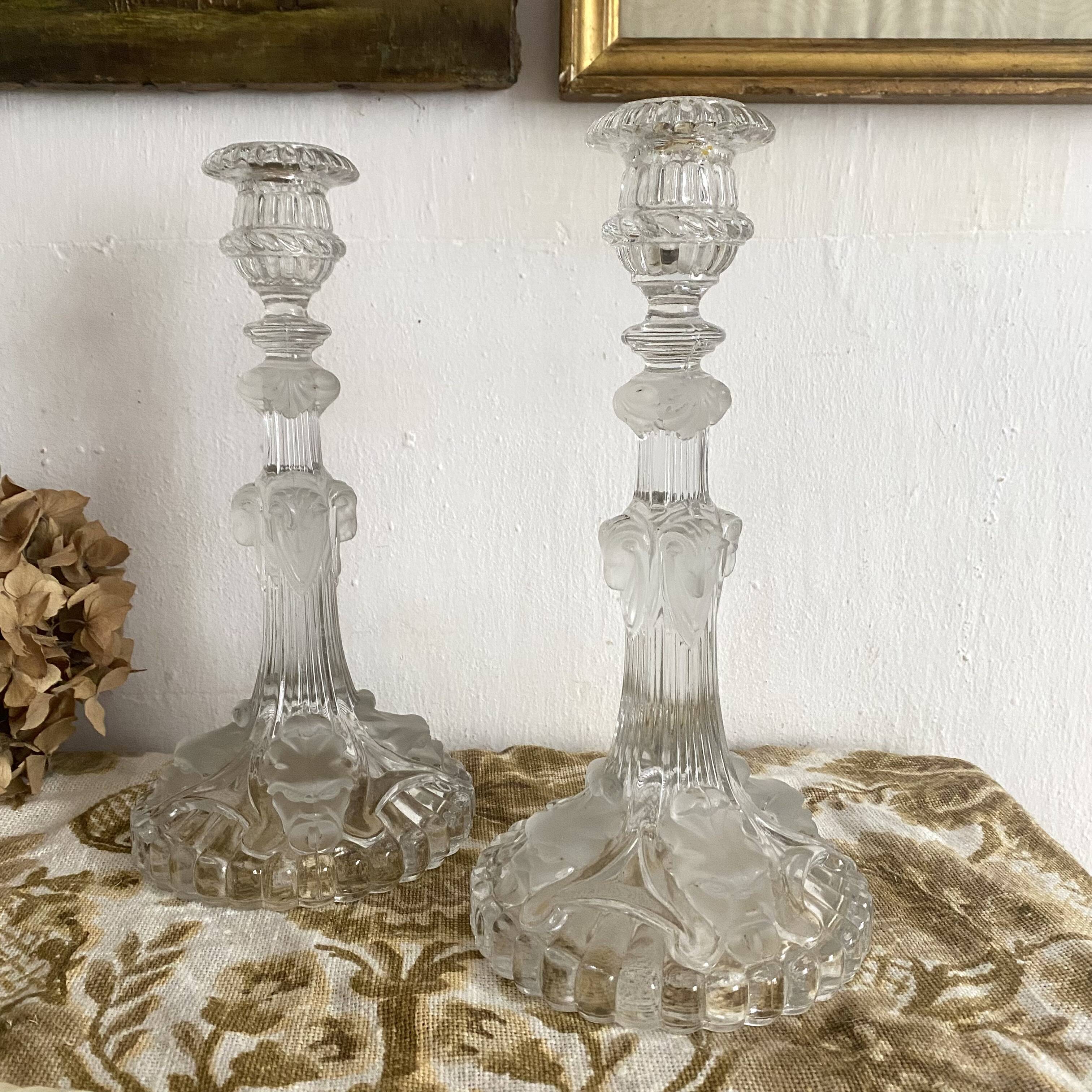Pair of moulded glass candlesticks, ram heads and masks