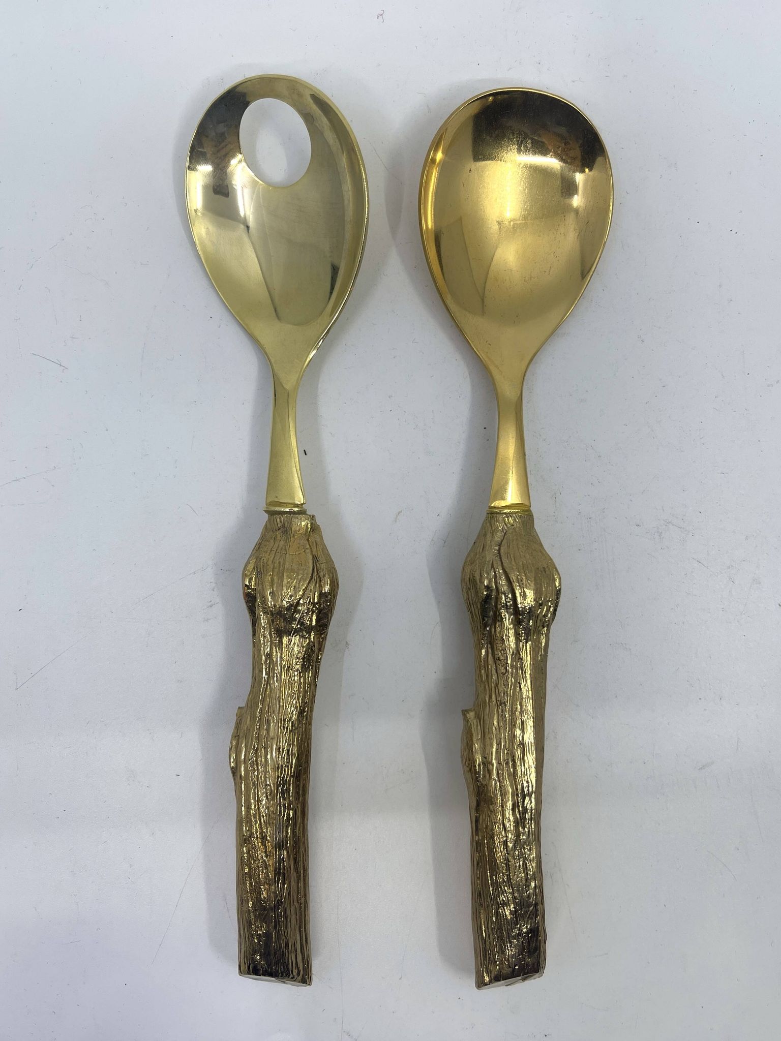 Lot of serving spoons, dessert spoon and fork in gold metal.