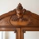 Antique walnut wardrobe with bevelled mirrors.