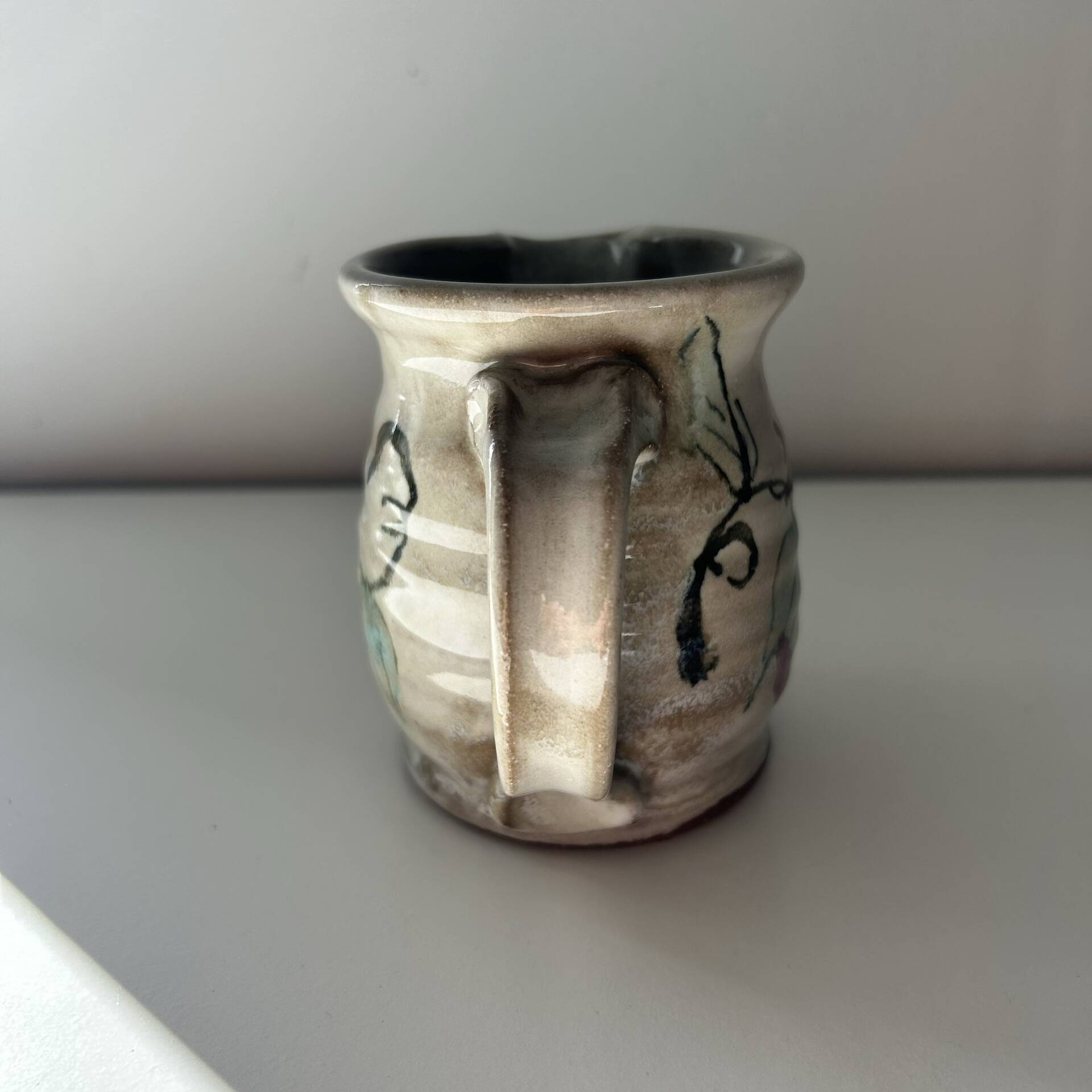 Floral decorated pitcher signed