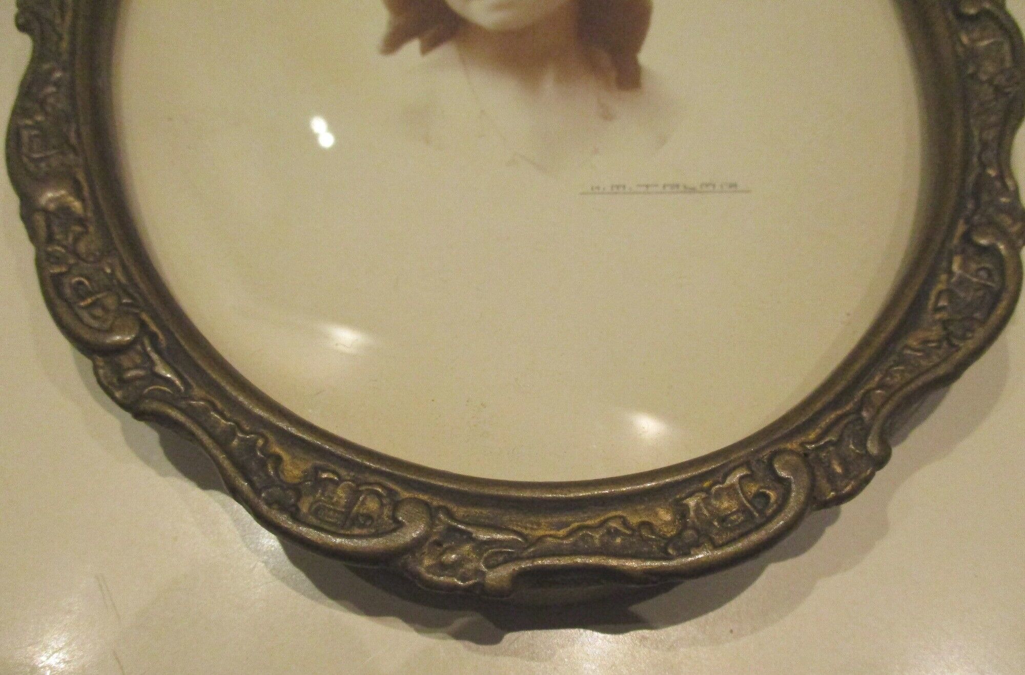 Old wall frame in carved wood and gilded stucco, oval