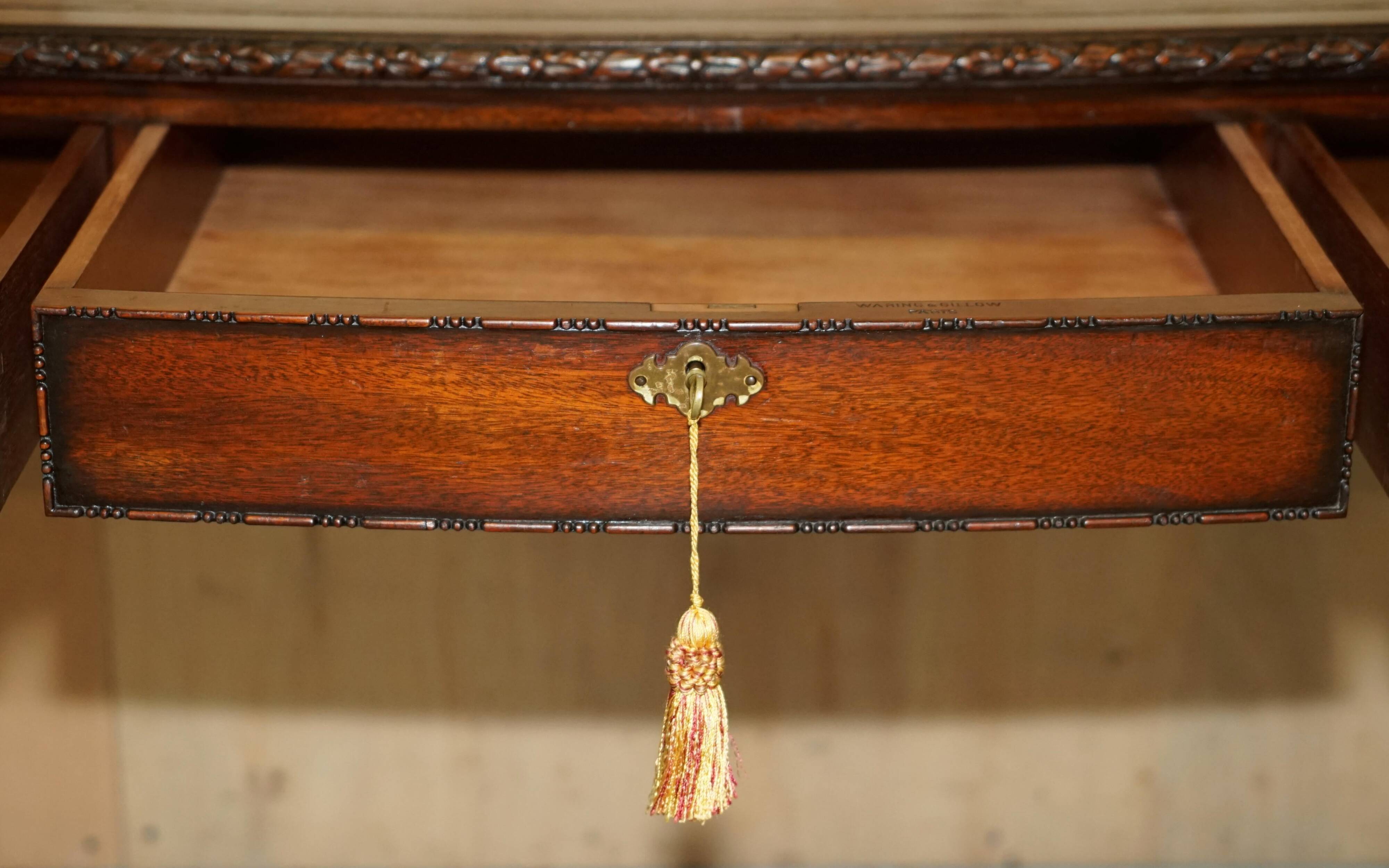 WARING & GILLOW library desk in the style of Thomas Chippendale with a leather top.
