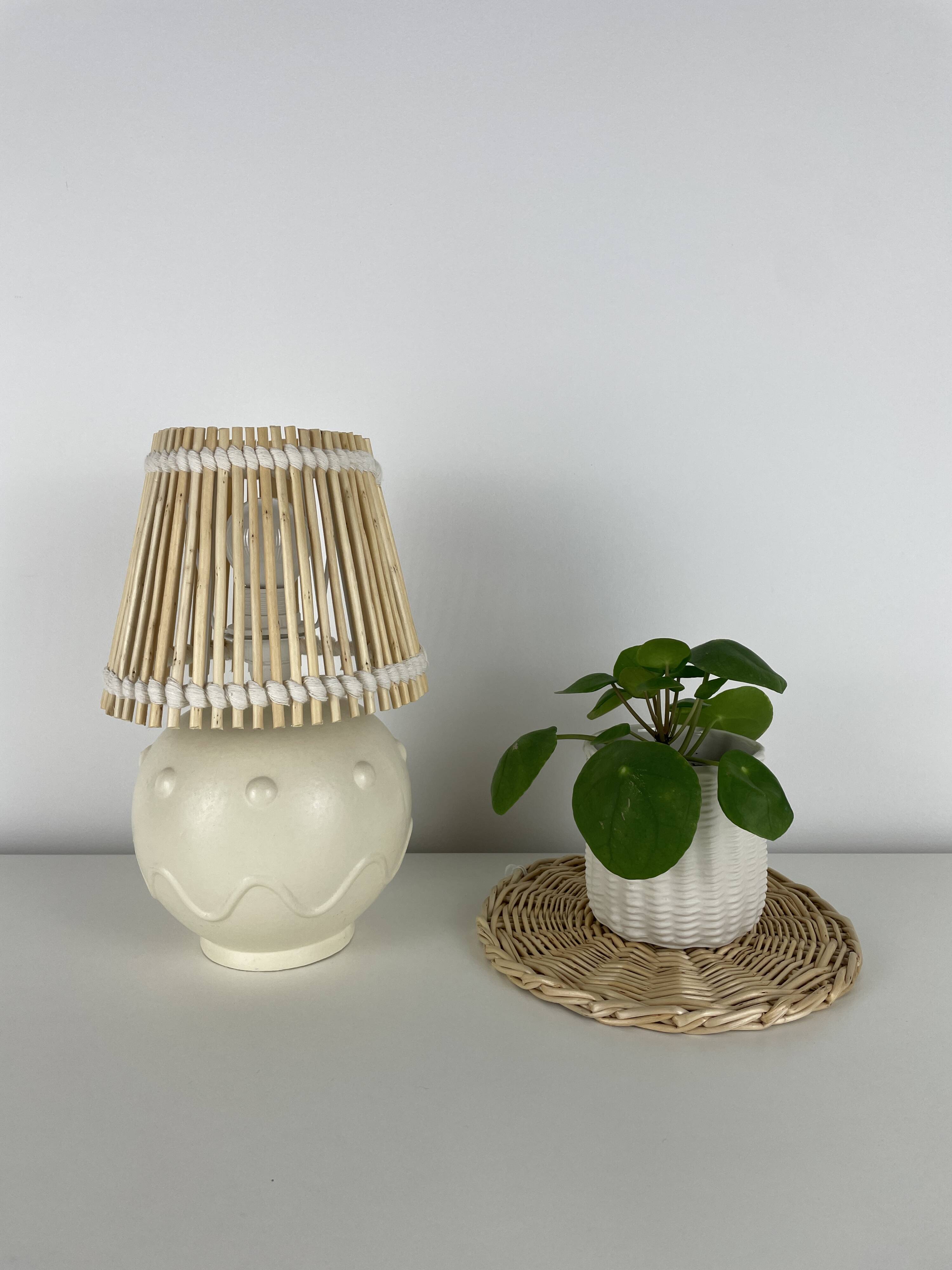 Vintage ceramic lamp with wicker and cotton shade.