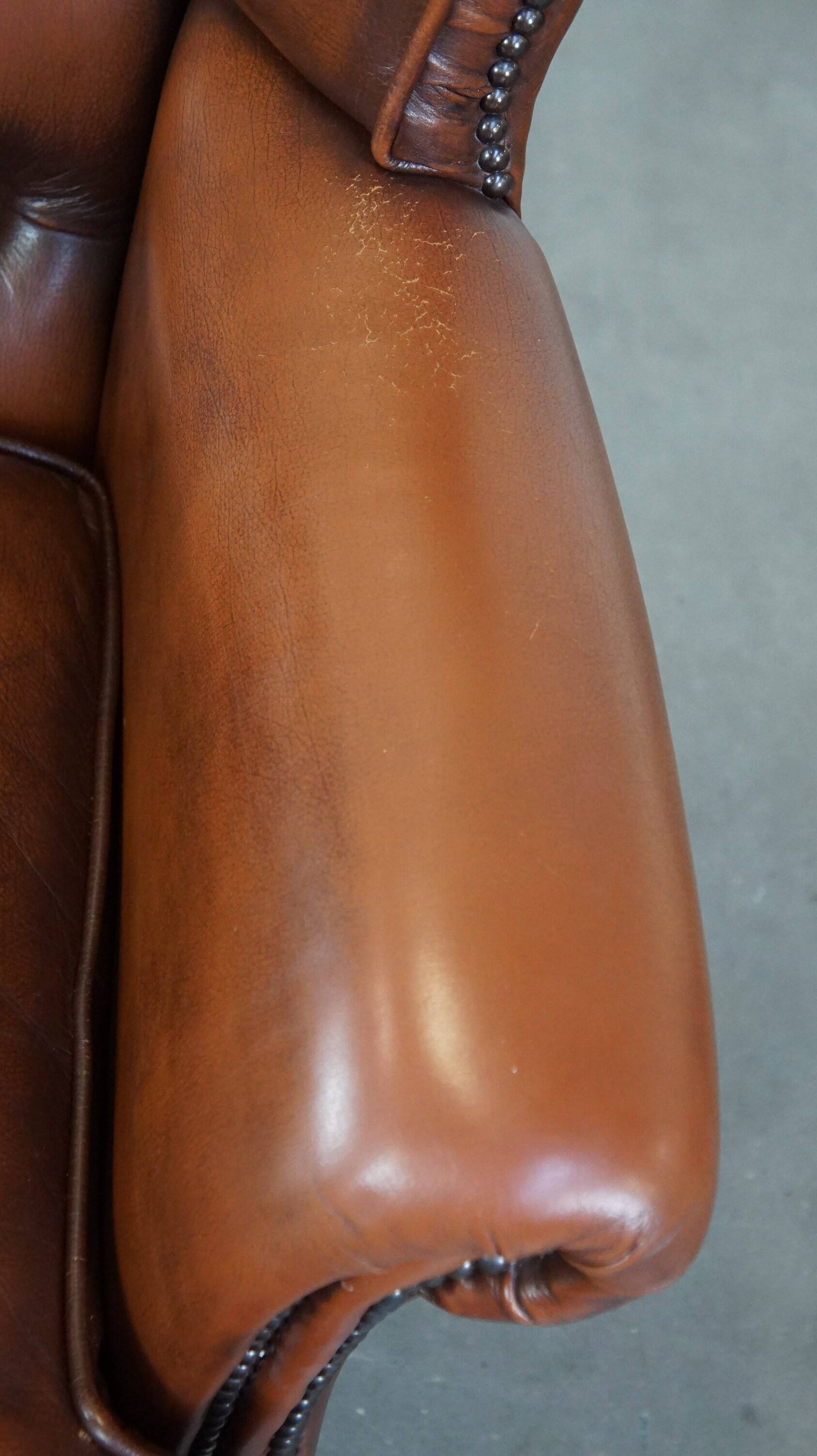 Brown leather wingback Chesterfield armchair