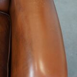 Very beautiful, stately, cowhide Chesterfield wing chair with elegant legs in a nice brown color