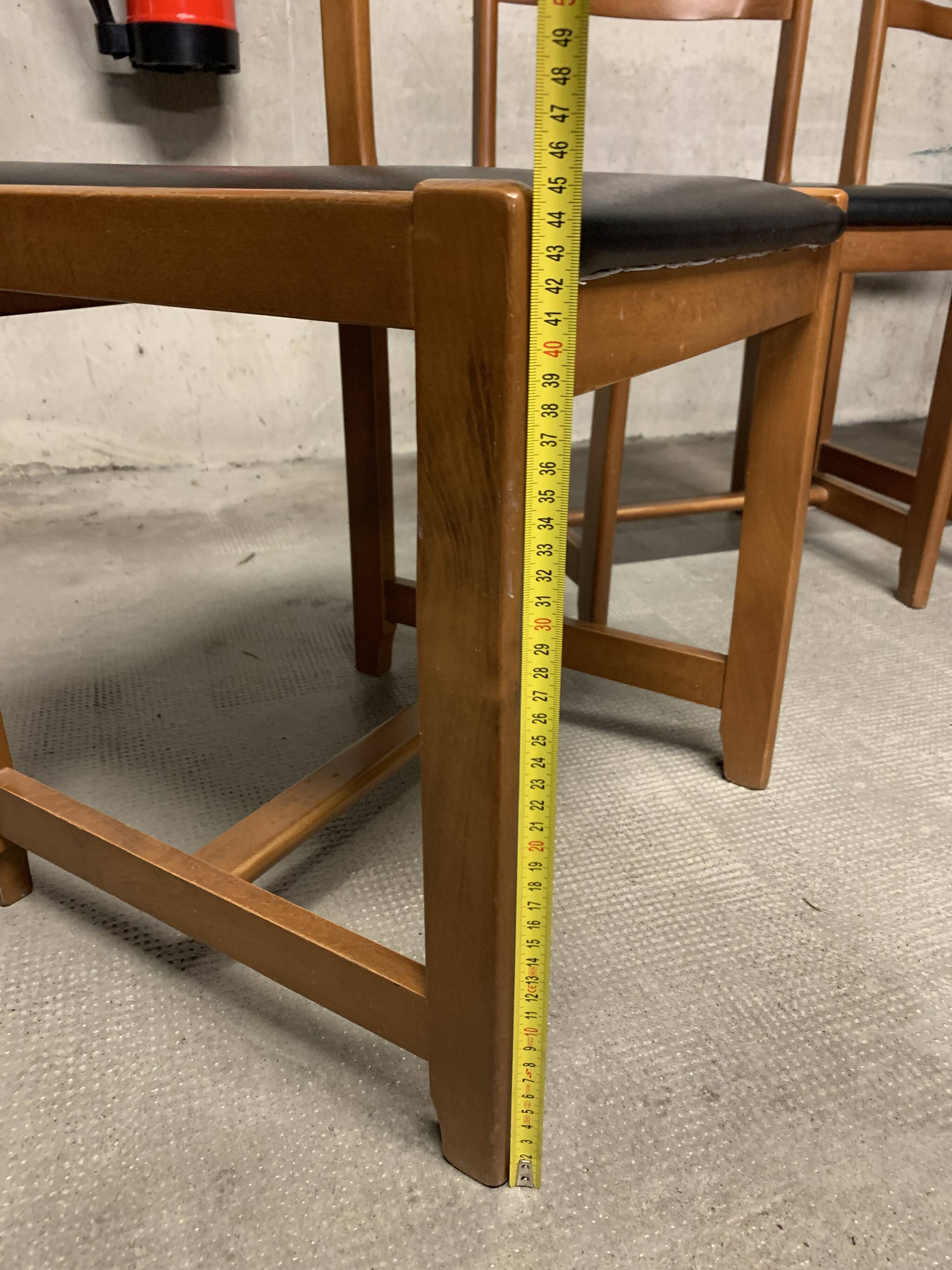 Set of four vintage chairs upholstered in retro design faux leather.