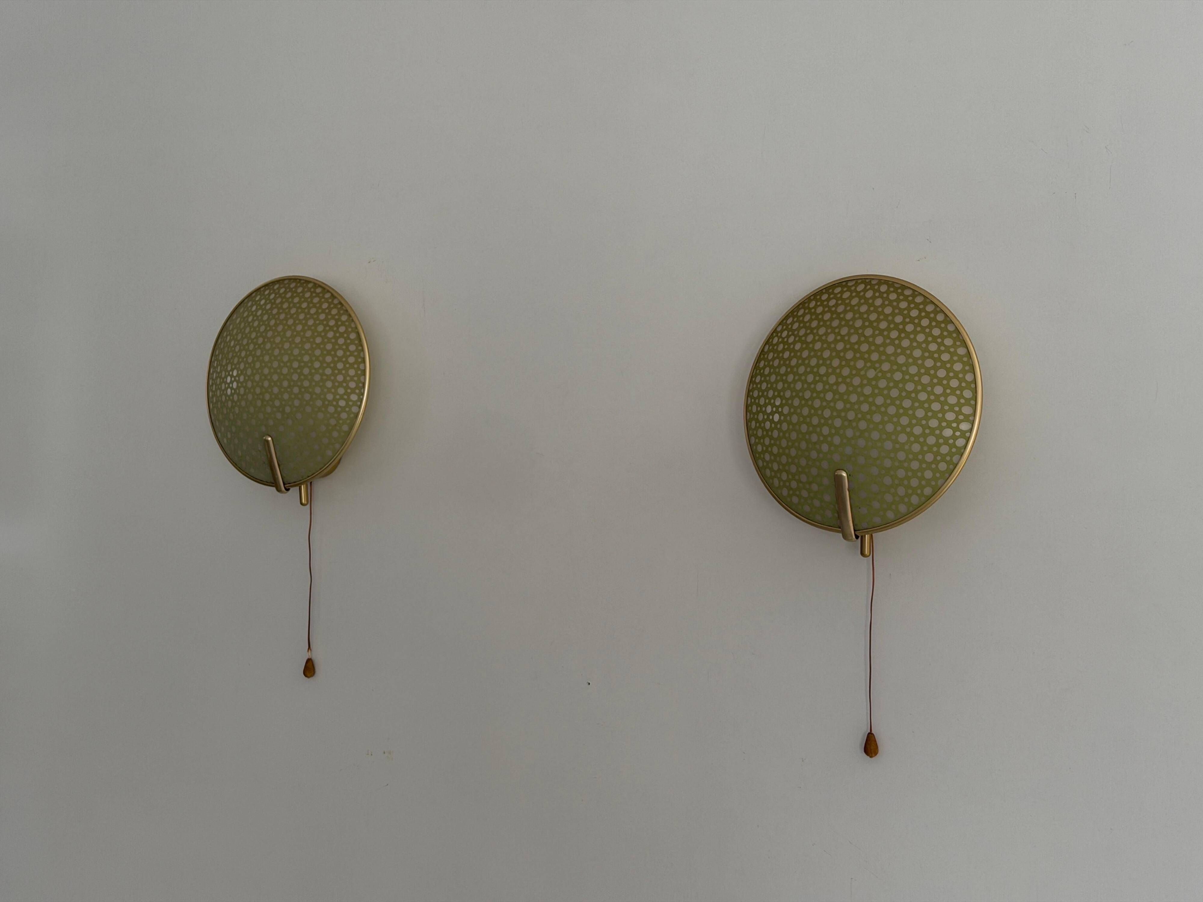 Pair of green plexiglass and gold metal wall lights by Erco, 1950s, Germany.