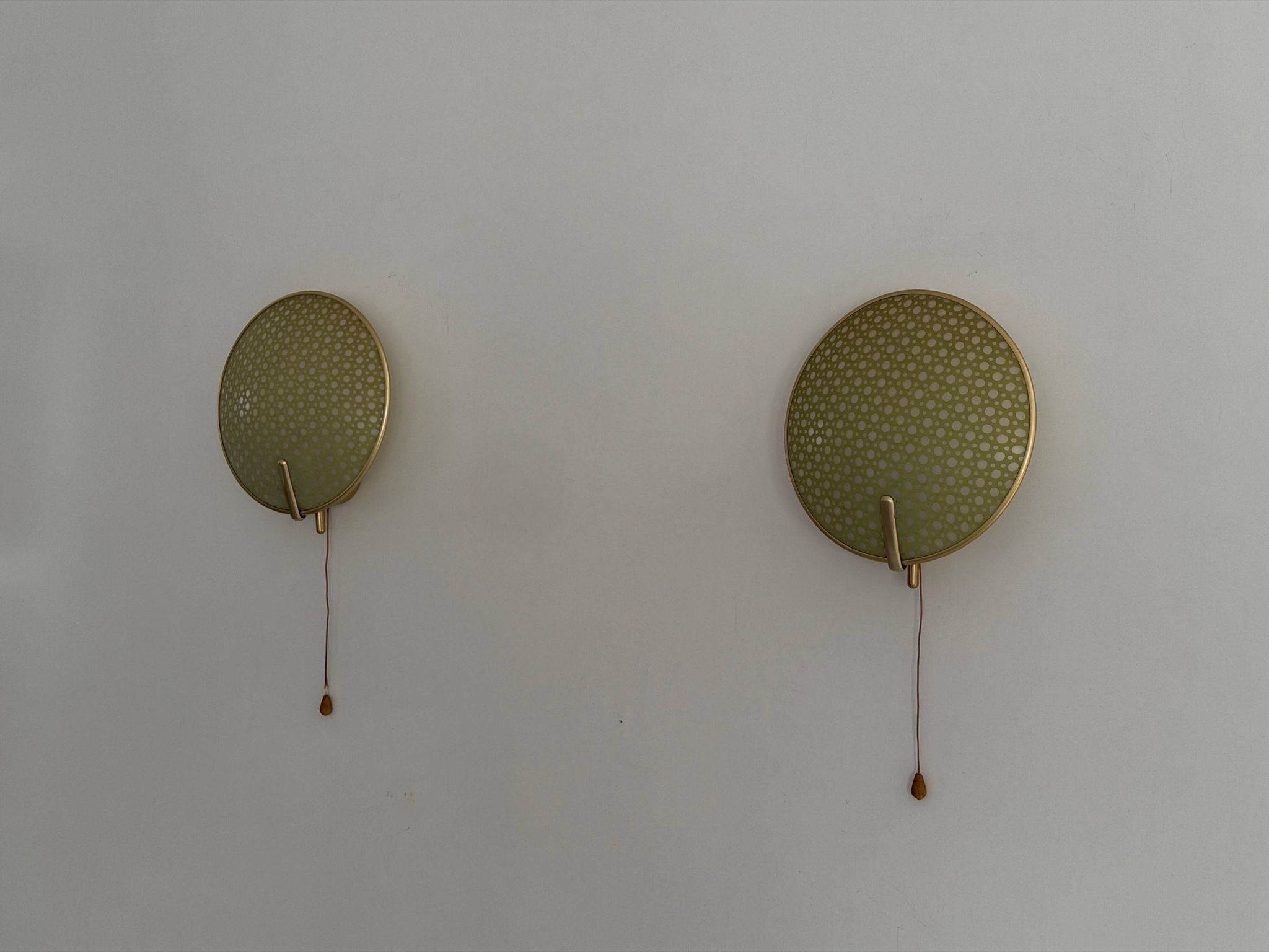 Pair of green plexiglass and gold metal wall lights by Erco, 1950s, Germany.