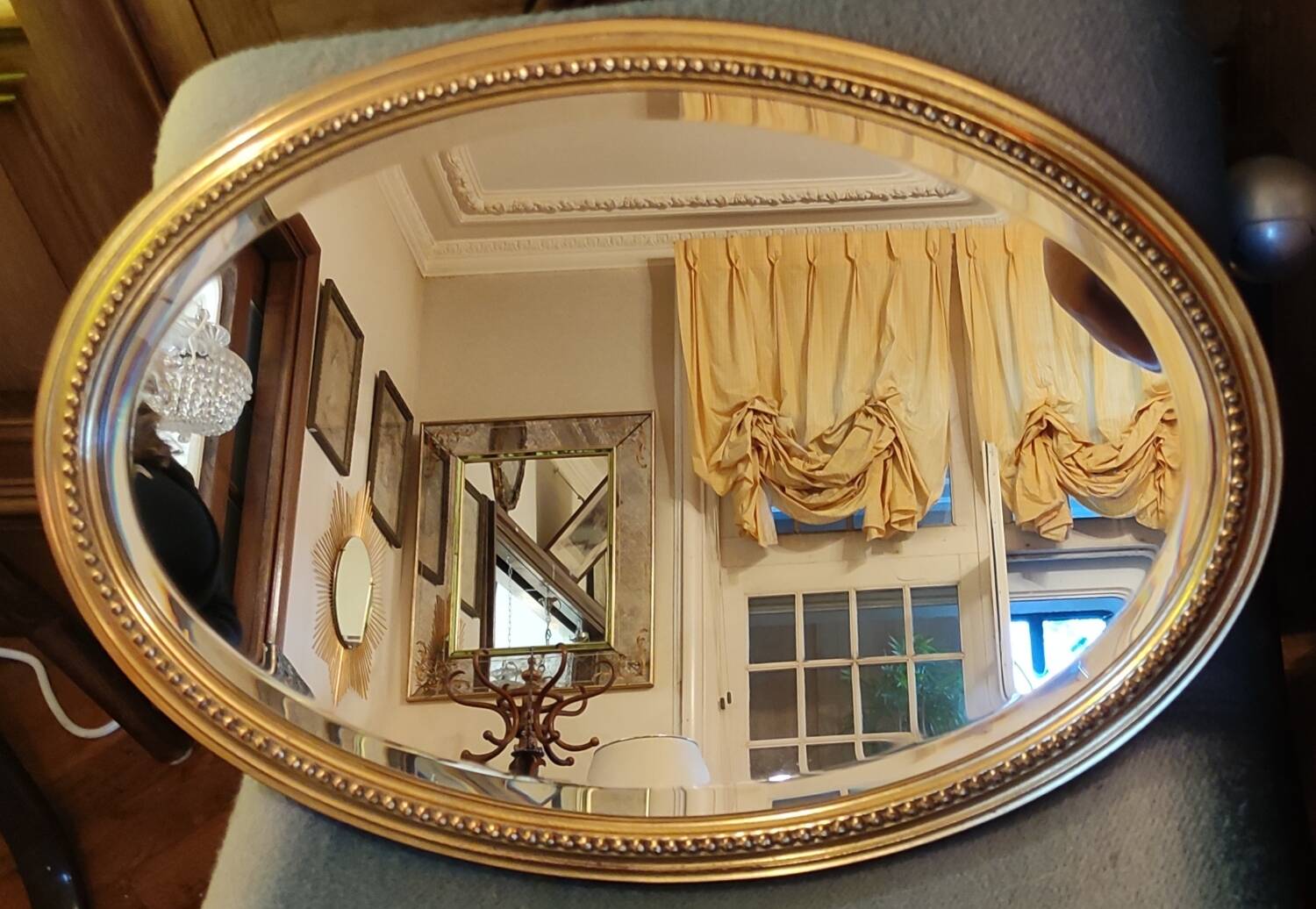 Old oval beveled golden mirror