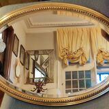 Old oval beveled golden mirror