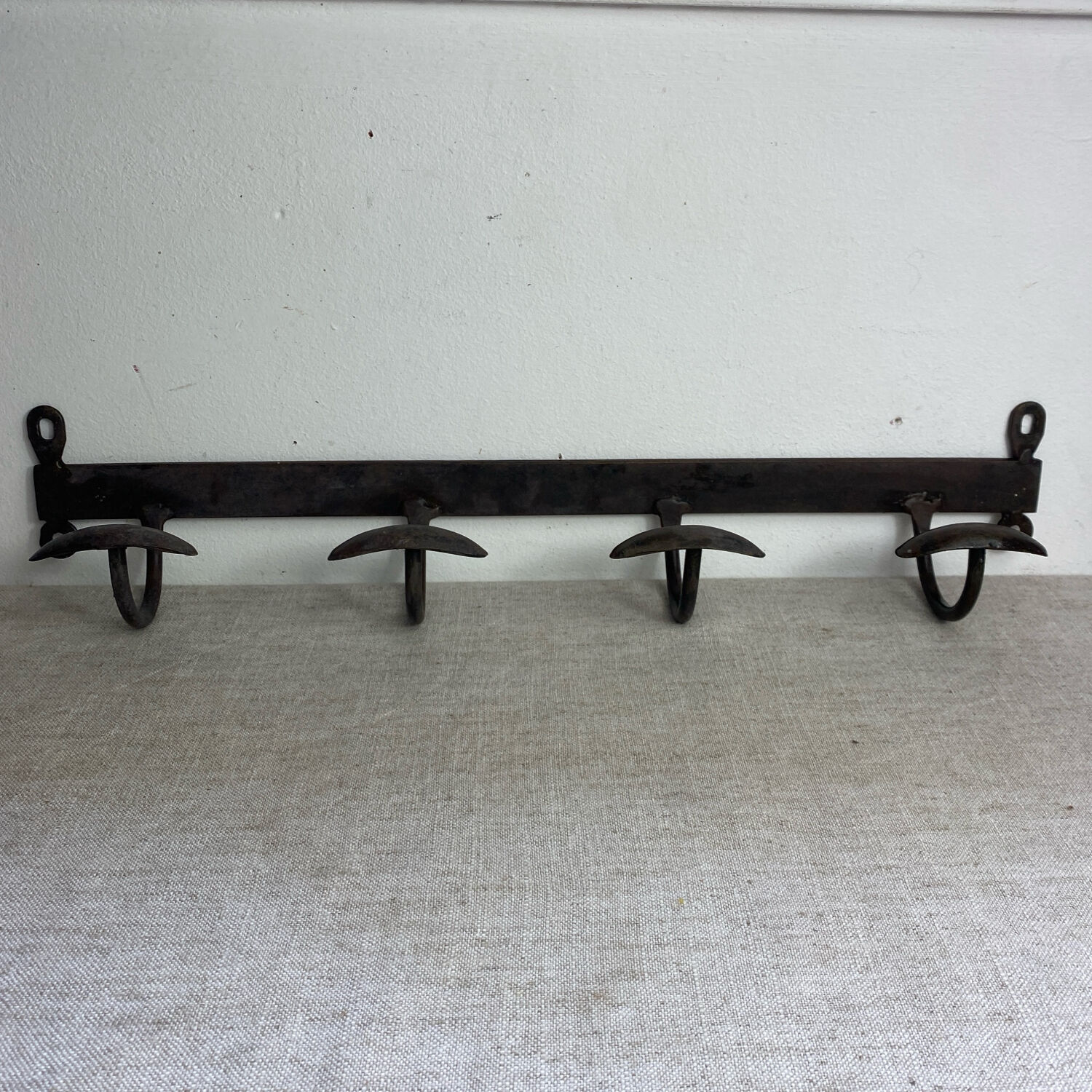Coat rack, four hooks, in wrought iron.