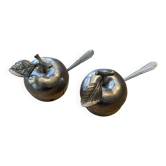 2salt or pepper shaker in the shape of an apple.