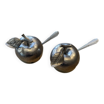 2salt or pepper shaker in the shape of an apple.