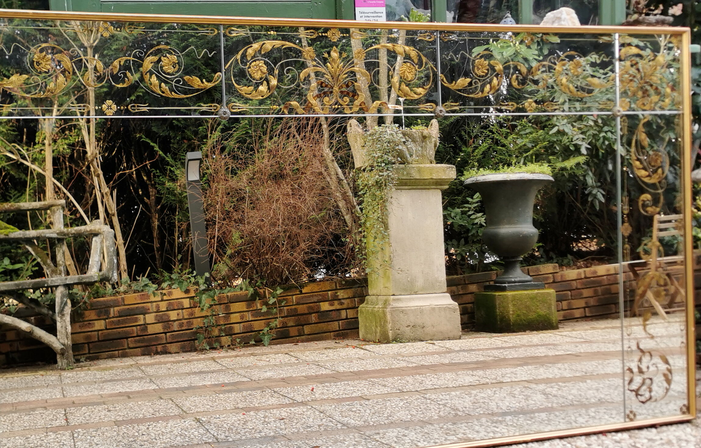 Glass mirror with a decoration engraved with golden foliage 1960