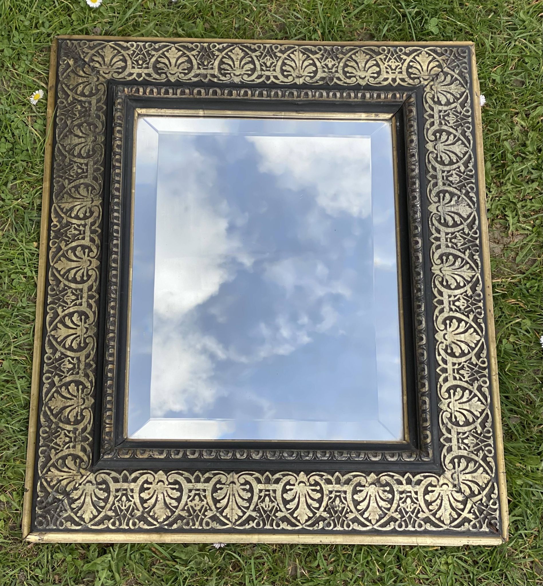 Bevelled mirror from the 19th century with gold and black palmettes.