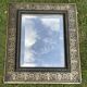 Bevelled mirror from the 19th century with gold and black palmettes.