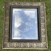 Bevelled mirror from the 19th century with gold and black palmettes.