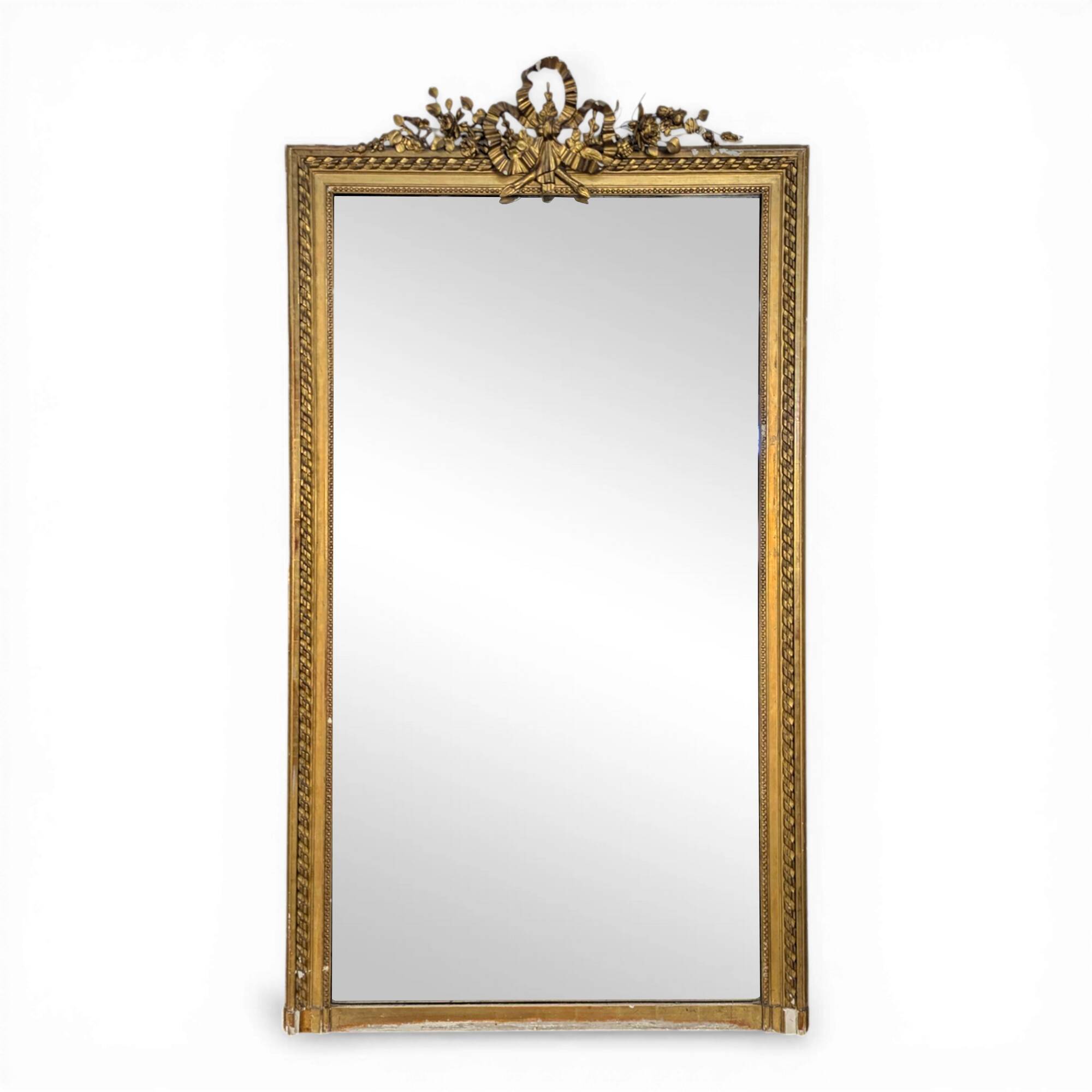 Golden Louis XVI style mirror with bouquet and shells.