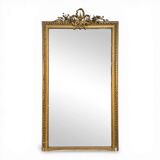 Golden Louis XVI style mirror with bouquet and shells.