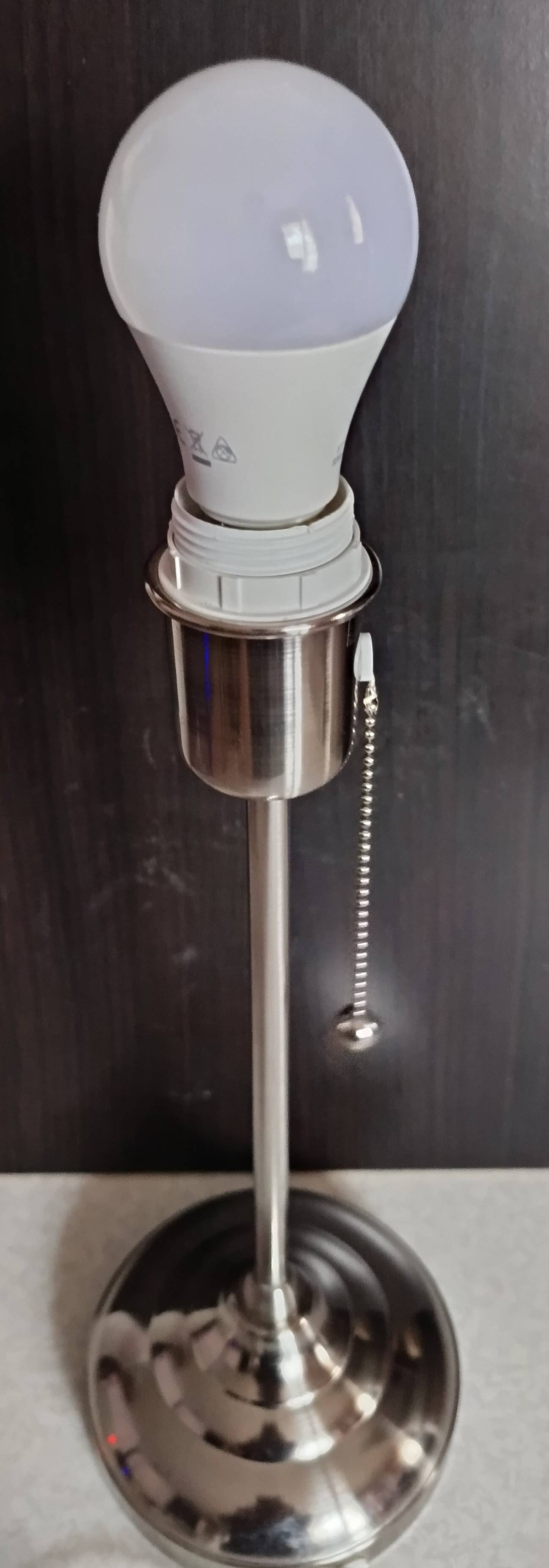 Modern white nickel lamp base with pull switch.