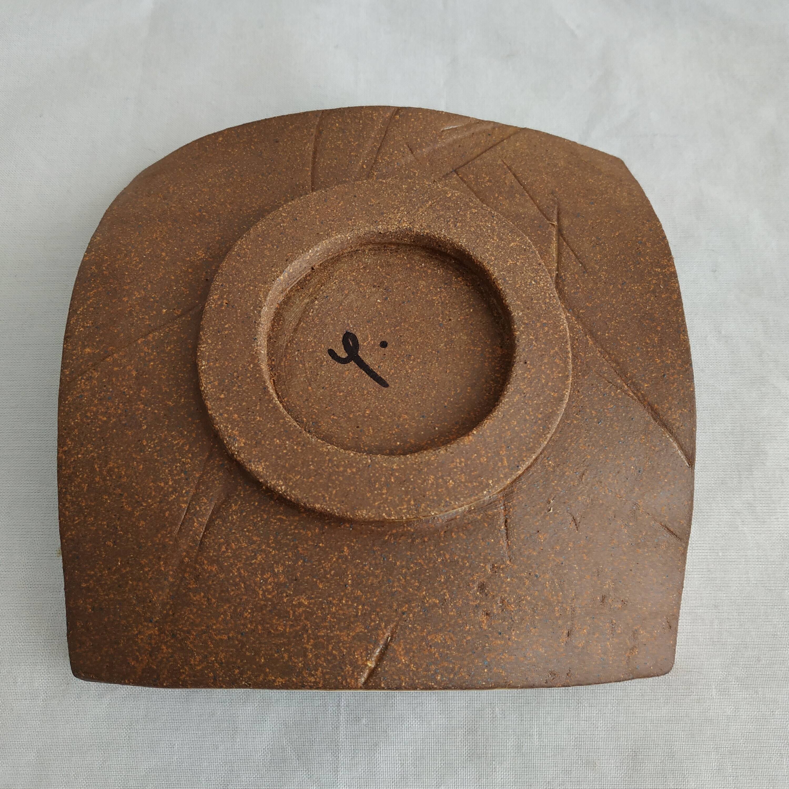 Two terracotta bowls with ethnic decoration and vintage signature.