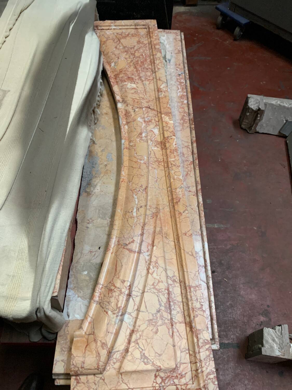 Louis XIV-style fireplace has 19th century veined pink marble hood