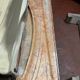 Louis XIV-style fireplace has 19th century veined pink marble hood