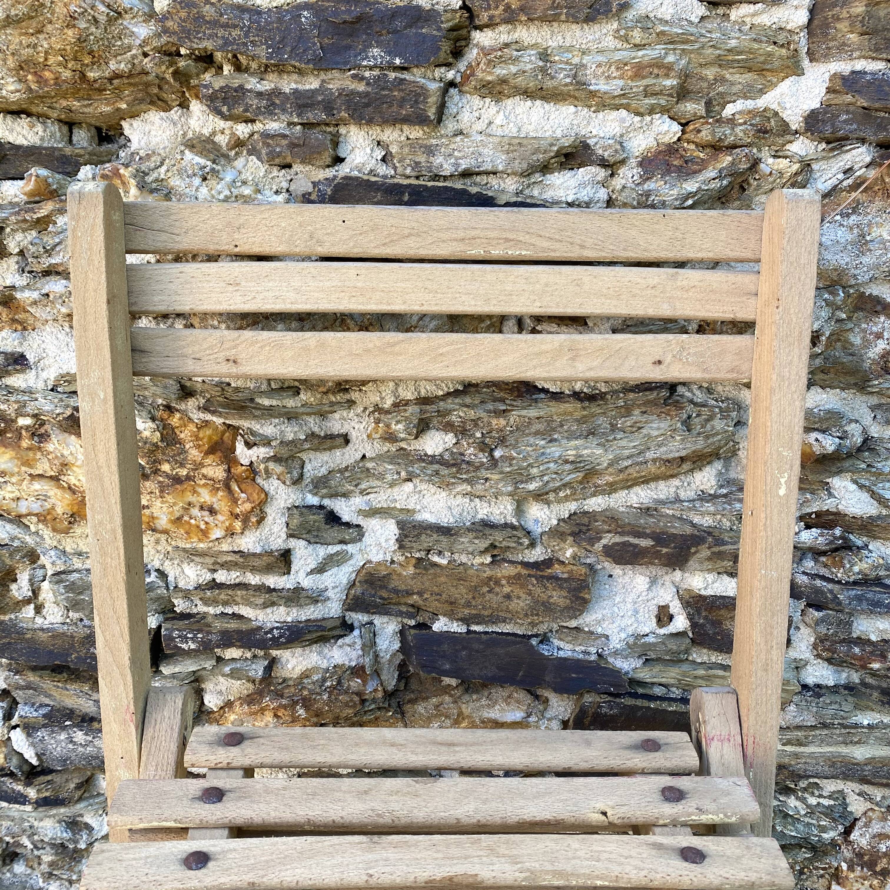 Antique folding chair with wooden slats
