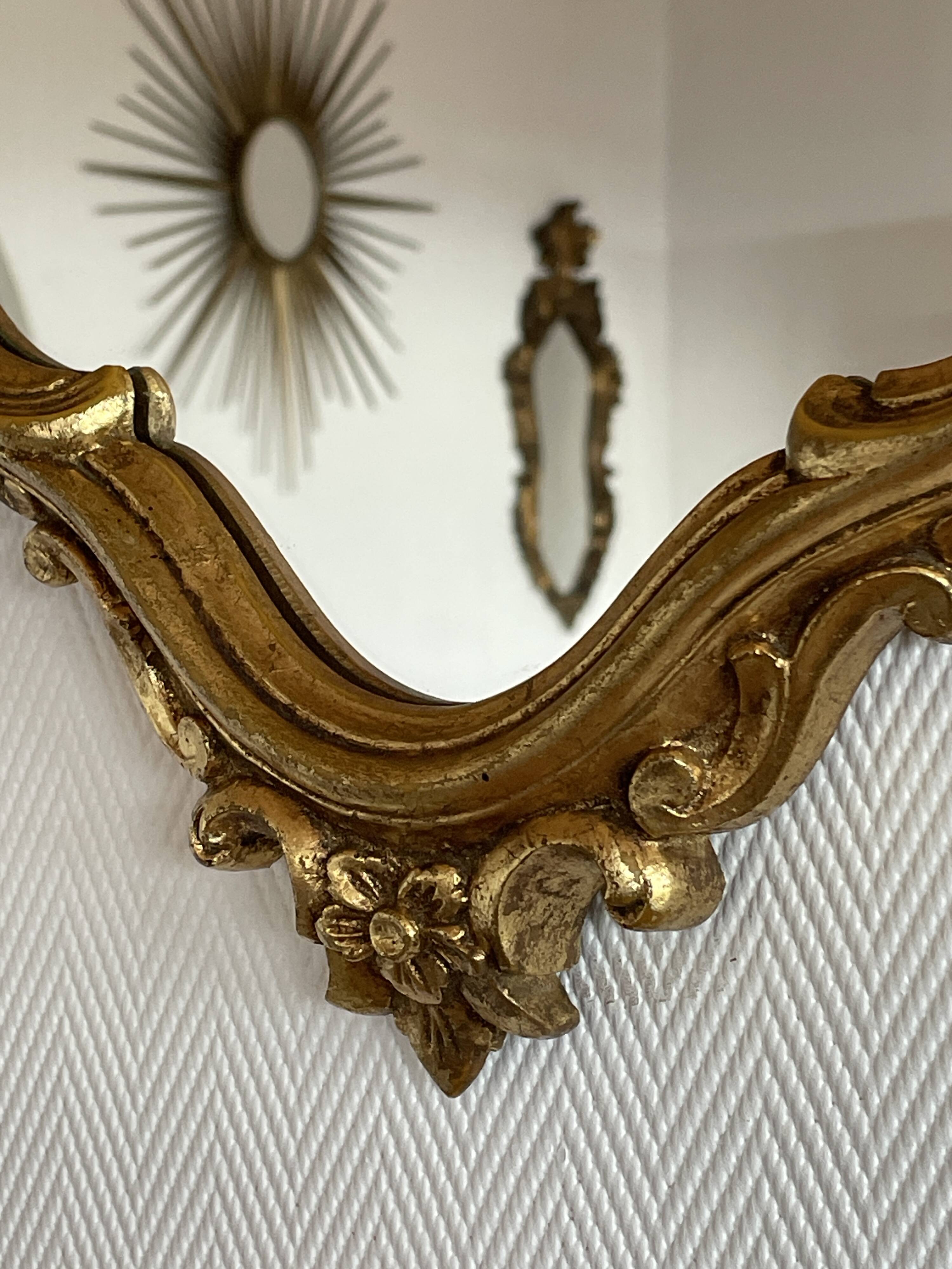 Old baroque style wall mirror with golden moldings