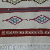 Tribal bohemian kilim rug with geometric pattern in wool.