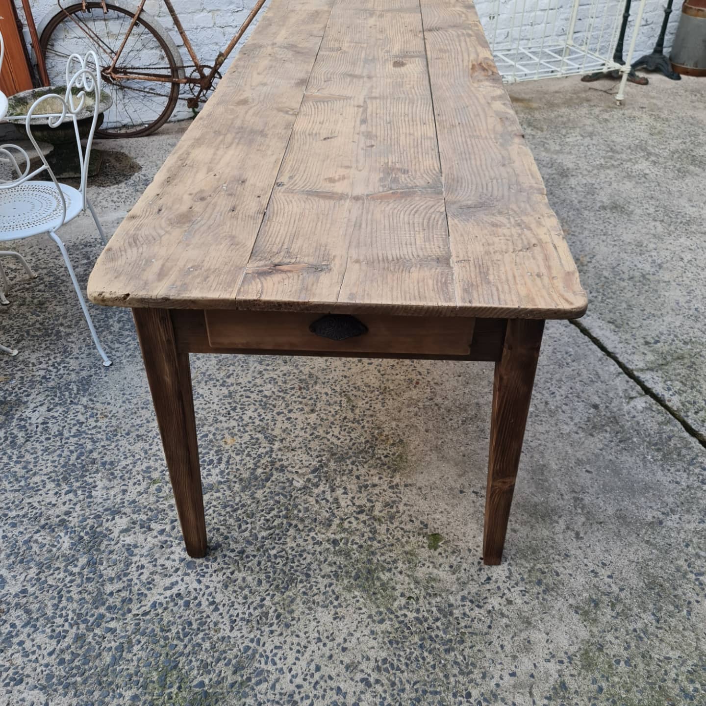 Large antique farmhouse table with a drawer